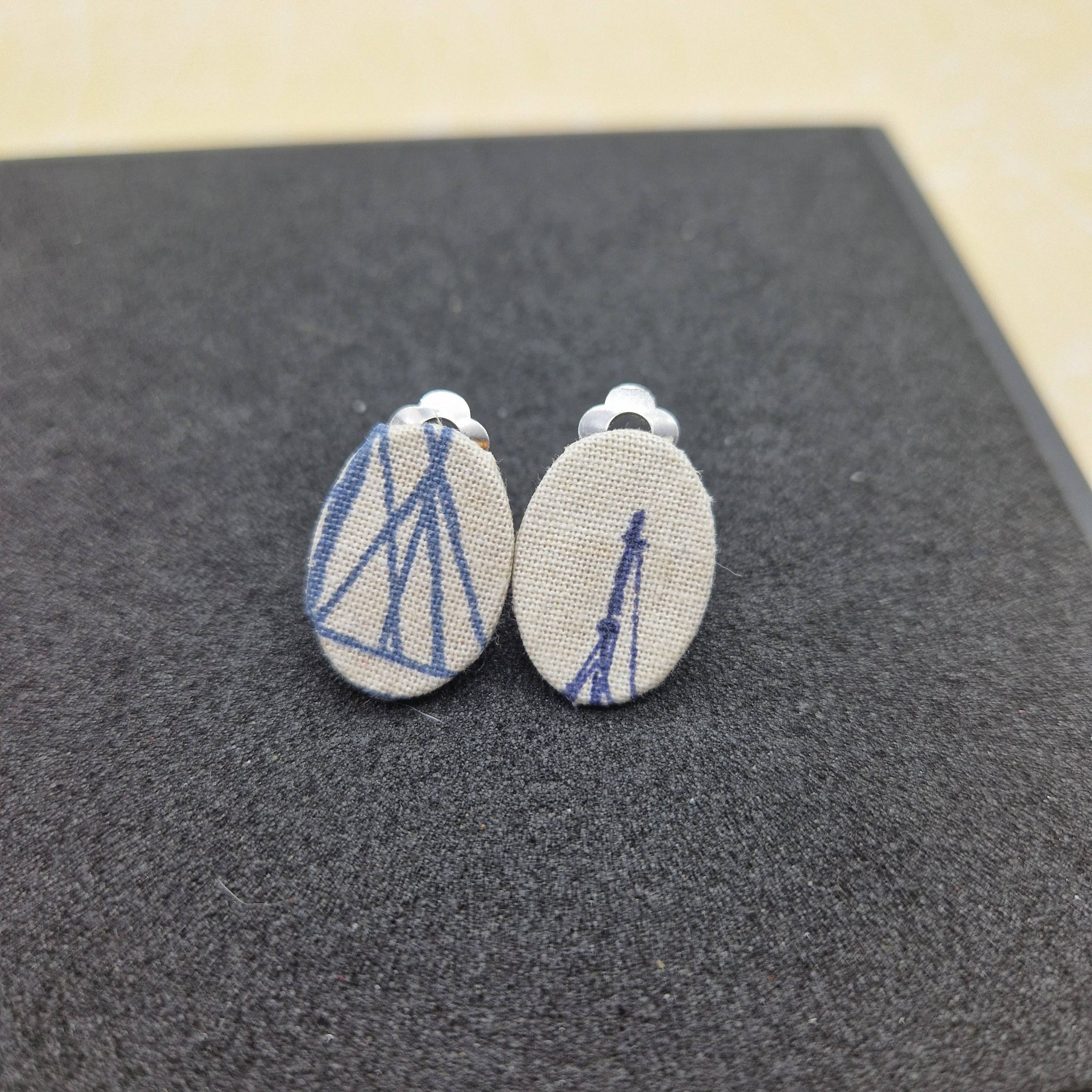 Cream clip on earrings with blue nautical design
