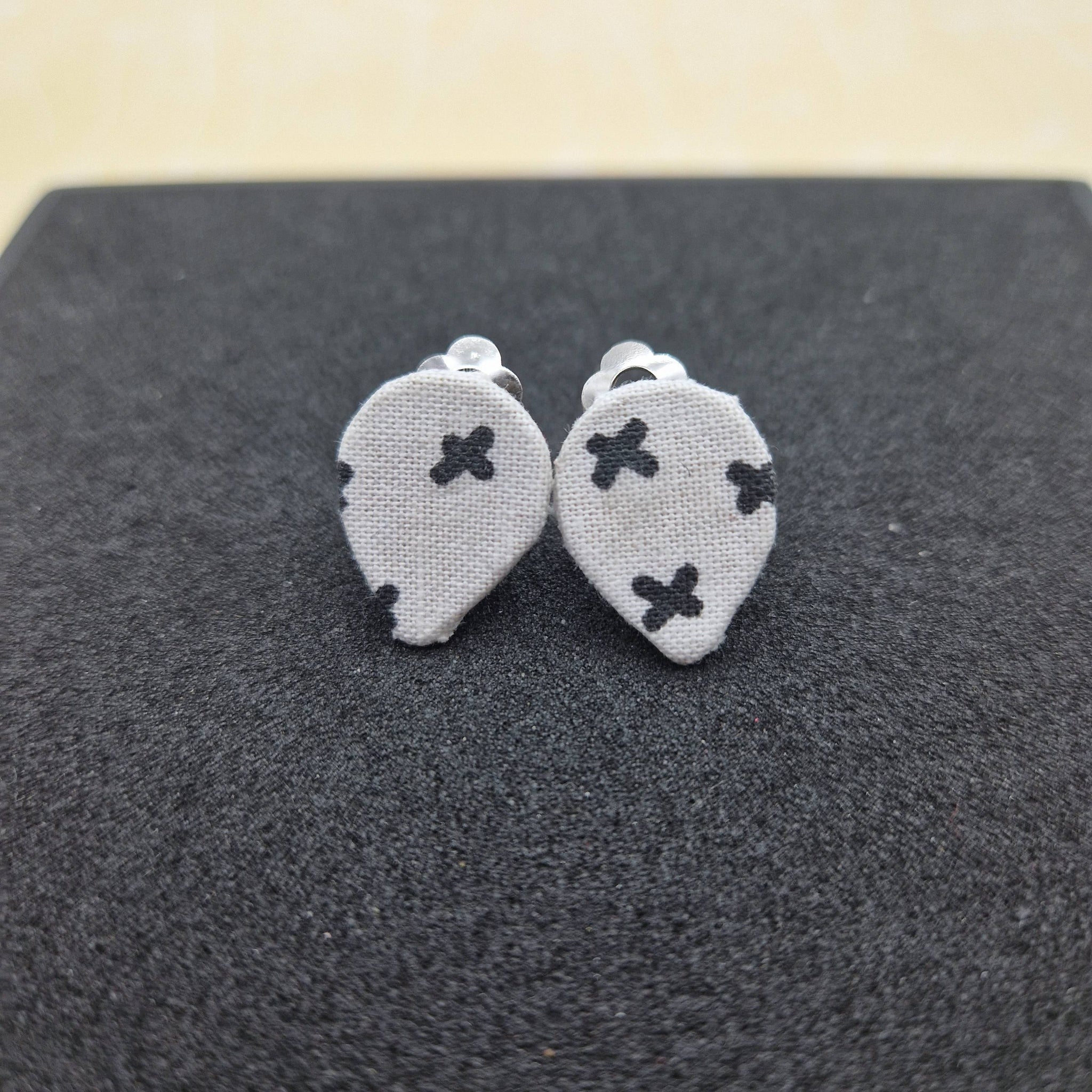 White teardrop with black crosses clip on earrings