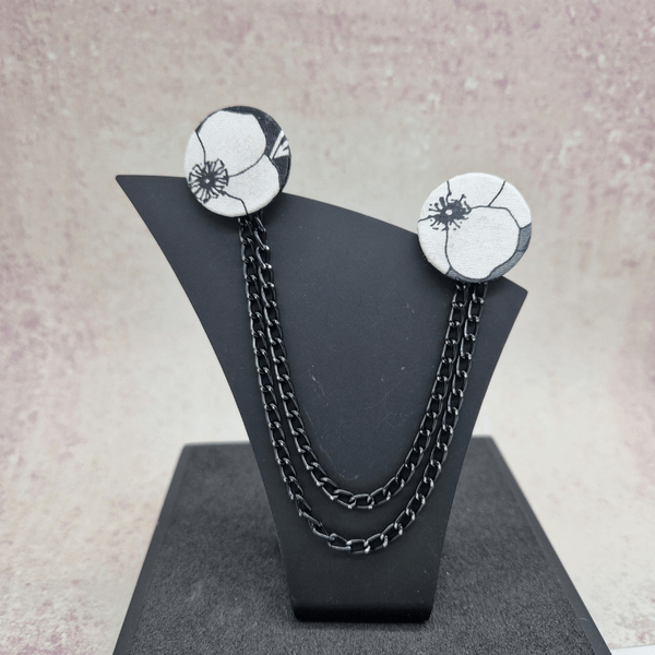 Black, white and grey Collar pins with black chain.