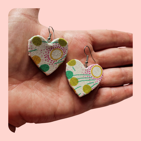 Green dangle heart fabric earrings, geometric design.