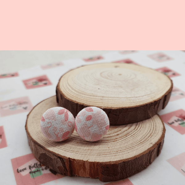 Pink and white floral fabric stud earrings.