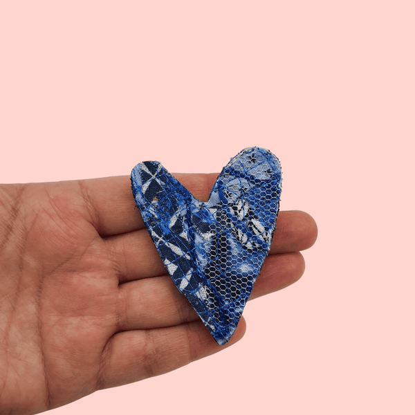  heart shaped fabric brooches created using scrap fabrics. blues with a black back.