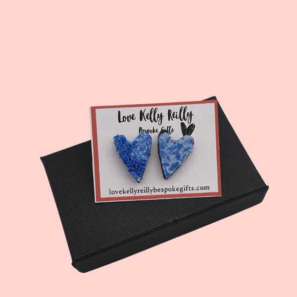 a pair of small heart shaped stud earrings. blue textile created with scraps of fabric on a love kelly reilly bespoke gifts logo card holder