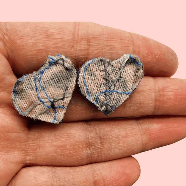 Small pink and grey heart shaped fabric stud earrings.