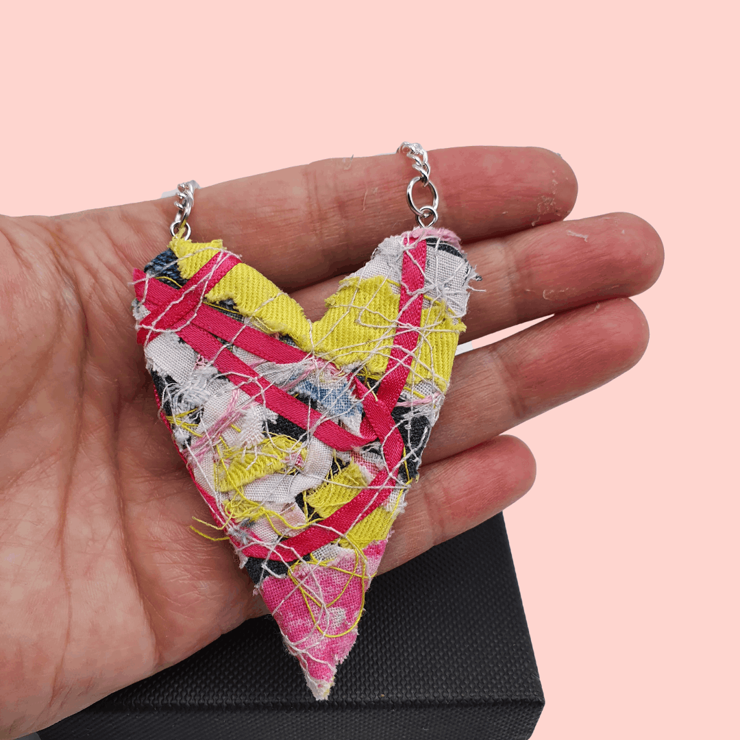 Pink ribbon and yellow upcycled fabric necklace.
