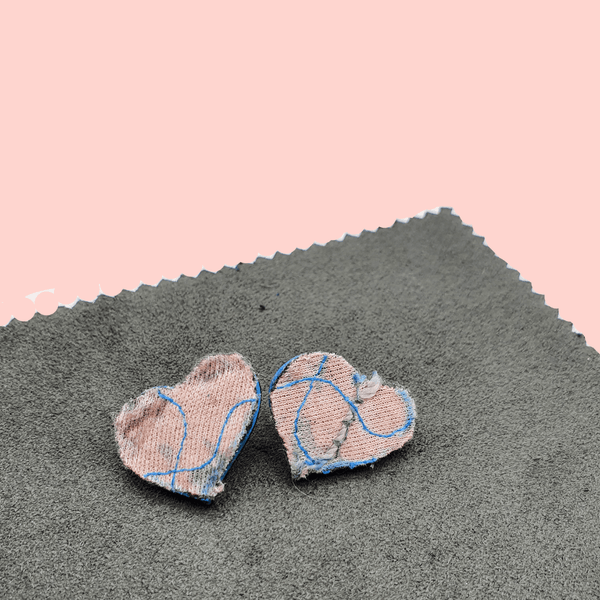 Small pink and grey heart shaped fabric stud earrings.