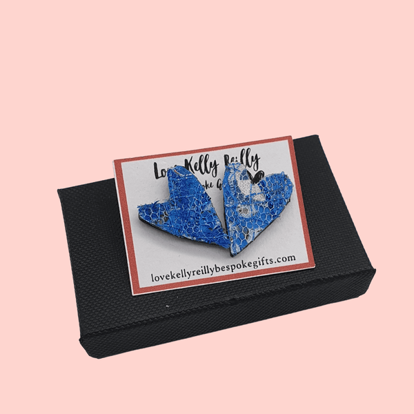 a pair of small heart shaped stud earrings. blue textile created with scraps of fabric on a love kelly reilly bespoke gifts logo card holder