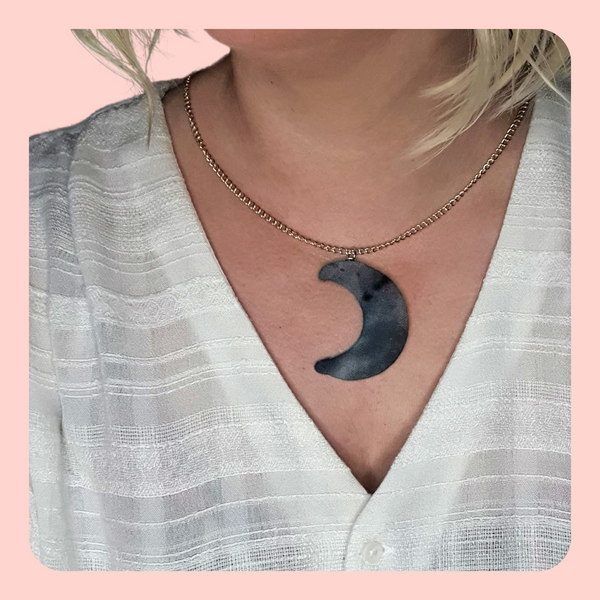 Grey and white moon shaped necklace and button earring set.