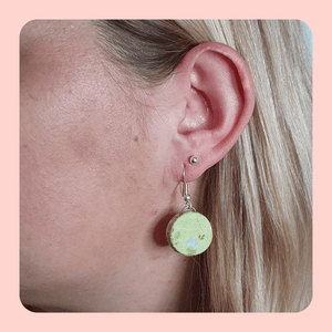 Green floral design fabric earrings.