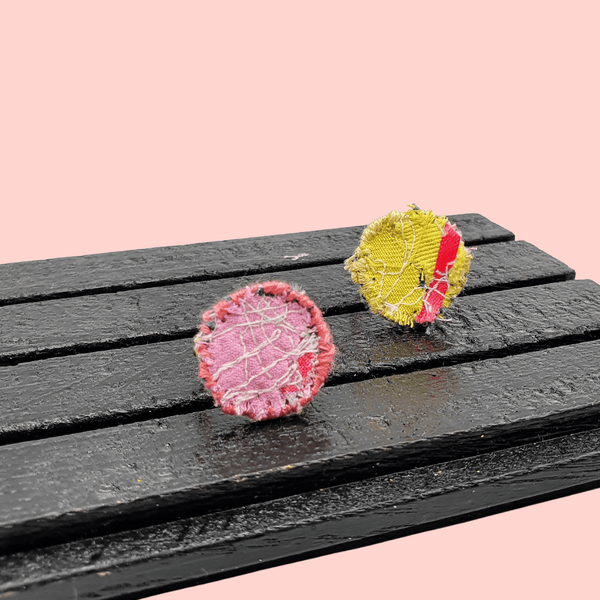 Two circle fabric rings; one pink and one yellow.
