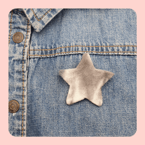 Star brooch in grey tie-dye fabric.