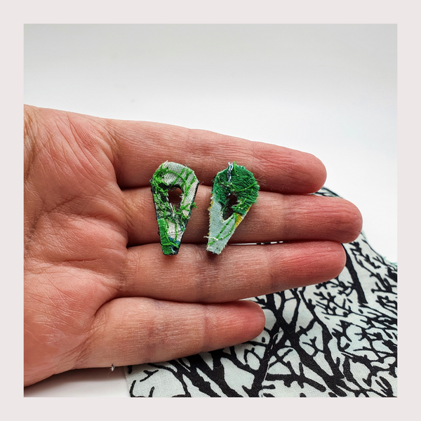 Small green leaf shaped fabric stud earrings.