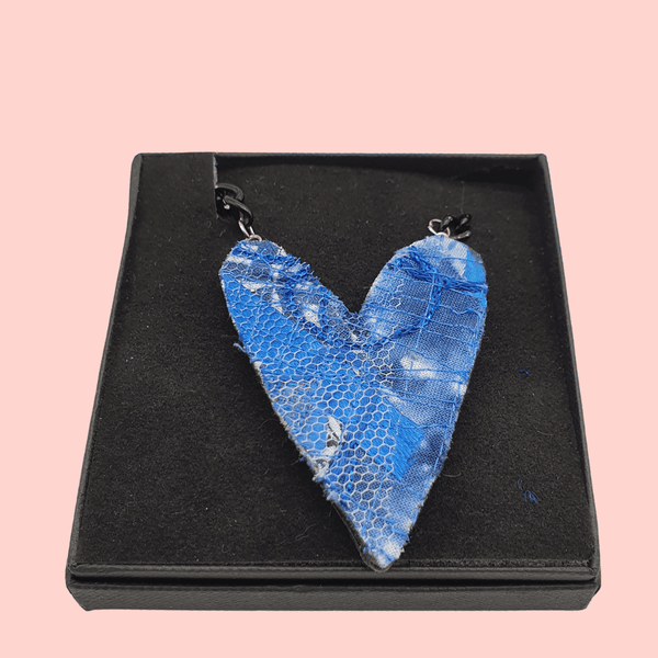 Blue heart necklace on a black curb chain in a black gift box