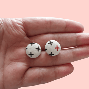 Button stud earrings, edgy cross design.