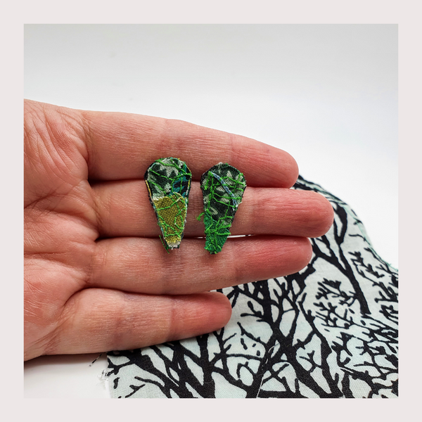 Small green leaf shaped fabric stud earrings.