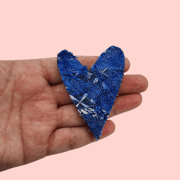  heart shaped fabric brooches created using scrap fabrics. blues with a black back.