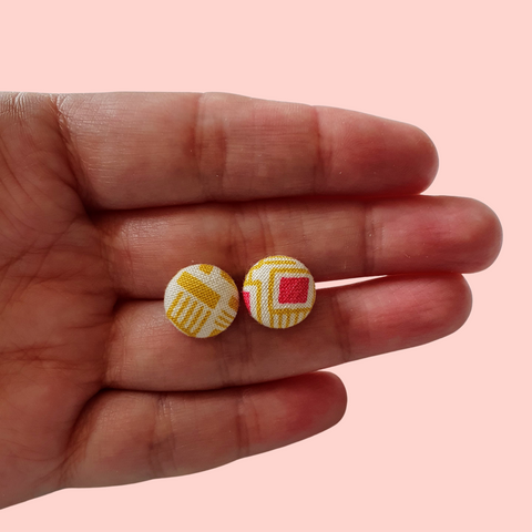 Mustard and pink retro button studs.