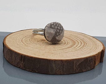 Fabric ring, various fabric designs with an adjustable band in silver tone.